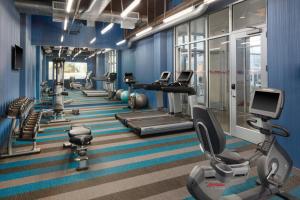 a gym with several treadmills and cardio machines at Aloft BWI Baltimore Washington International Airport in Linthicum Heights
