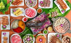 a table filled with different types of food on plates at Horizon Resort & Spa Yalong Bay-Yalong Bay Central in Sanya