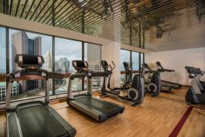 a gym with cardio machines and a view of the city at The Plaza Hotel Columbus at Capitol Square in Columbus