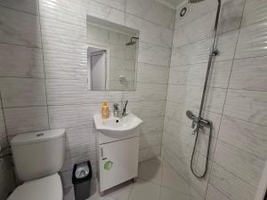 a bathroom with a toilet and a sink and a shower at Ruse Charm Studio 3 in Ruse +17 photos