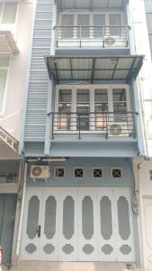 a blue building with a balcony and a porch at CBD Studio Loft 2A at City Center! in Medan