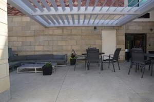 a patio with a couch and tables and chairs at Fairfield Inn & Suites by Marriott Denver Aurora/Parker in Foxfield