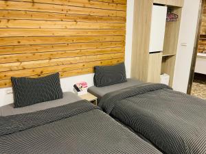 two beds sitting next to each other in a room at Chingya House in Beigan