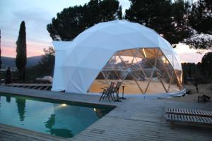 a tent is set up by a swimming pool at MasQi, The Energy House in Bañeres de Mariola