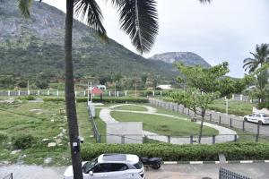 a car parked in a parking lot next to a mountain at Brick House at Nandi in Bengaluru