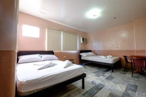 Postel nebo postele na pokoji v ubytování GV Hotel - Ozamiz