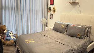 une chambre avec un lit et un ours en peluche dans l'établissement Selena, à Long Bình