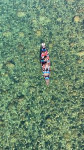 a group of people in a boat in the water at shnongpdeng tents stay in Dawki