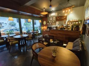 a restaurant with tables and chairs and a bar at Anand Bhawan in New Delhi