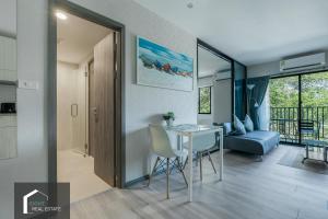 Una cocina y una sala de estar con mesa y sillas. en Cozy apartment by the sea F410, en Nai Yang Beach 35 fotos más