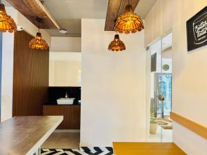 a kitchen with orange lights hanging from the ceiling at Hotel Bilton Wilson Garden Near Nimhans Hospital in Bangalore