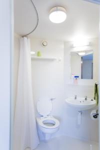 a white bathroom with a toilet and a sink at University of Essex - Colchester Campus in Colchester