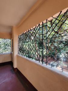 a window in a room with a view of a tree at Niribili Homestay in Lodhāsuli