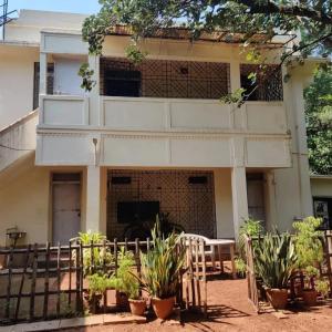 a building with plants in front of it at Niribili Homestay in Lodhāsuli