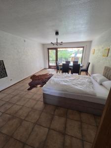a bedroom with a bed and a table and chairs at Garten EG Wohnung mit 3 Schlafzimmern 95qm in Karlsfeld