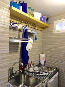 a kitchen with a sink and a counter top at Il mare in un Boccaccio in Polignano a Mare