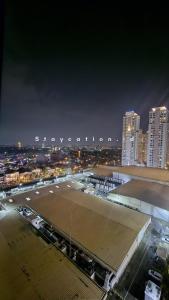 a view of a large parking lot at night at Apart Anderson in Surabaya