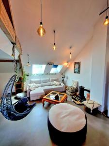 a large living room with a couch and a table at Le Familia in Pacy-sur-Eure