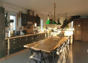 a large kitchen with a wooden table and chairs at Le Familia in Pacy-sur-Eure