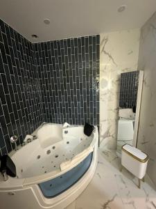 a bathroom with a tub and a sink and a mirror at MOON - 44 in Nice