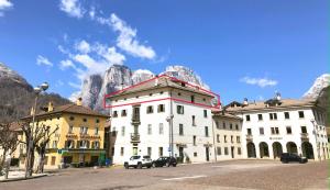 a group of buildings in front of a mountain at Dolomites Luxury Penthouse in Agordo