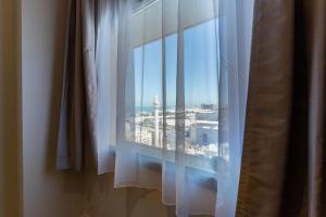 a window with a view of a city at Premier Inn Doha Airport in Doha