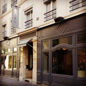 a store front of a building on a street at Hôtel Jacques de Molay - Fitness & Sauna in Paris