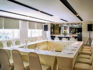 a conference room with a long table and chairs at Mercure Kota Kinabalu City Centre in Kota Kinabalu +68 photos