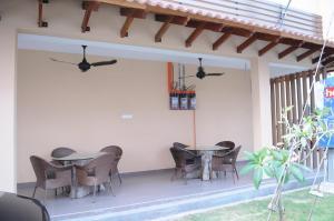 a patio with tables and chairs on a house at Marina Oriental Hotel in Butterworth