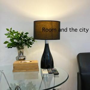 a lamp on a table with a room and the city on it at Rimklong boutique hotel trad in Trat