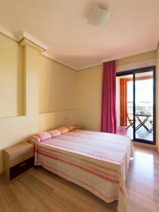 a bedroom with a bed and a large window at Vilamar VyB in Denia