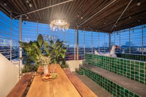 a large room with a wooden table and a chandelier at The Onyx Pearl Hanoi-Stylish Retreat with Rooftop Pool-Near Street Food in Hanoi