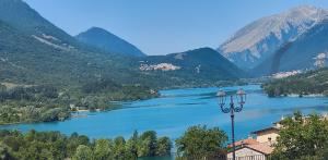 a view of a lake with mountains in the background at Verdeblu in Barrea +8 photos