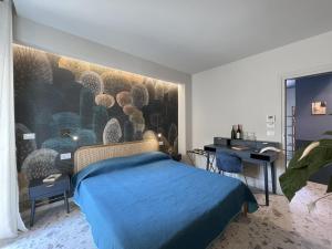 a bedroom with a blue bed and a painting on the wall at Casa Spizziculia in Parghelia