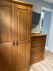 a wooden cabinet with a television on top of it at The Lodge in Perranporth