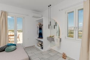 a living room with white walls and windows at Birbas Hotel in Agia Anna Naxos +54 photos