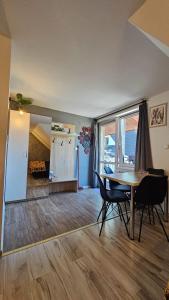 a dining room with a table and chairs in a room at Apartament Jaskier in Zakopane