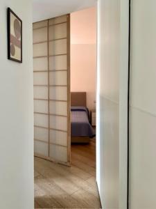 a room with a door leading to a bedroom at Oasis of Design Milano Fair, Polimi, S Siro, Olympics Game in Milan