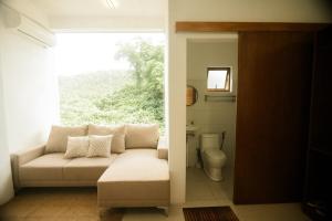 a living room with a couch and a window at Who's Gloria in El Nido +83 photos