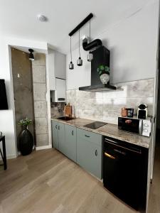a kitchen with a black and gray counter top at La Arquita, tu apartamento en Valladolid in Valladolid