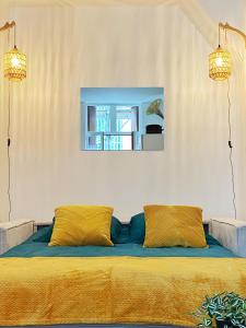 a bed with two pillows in a room at Studio Cosy & bohème - Quartier Cauchoise in Rouen