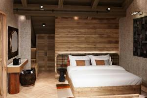 a bedroom with a large bed and a wooden wall at Ceylan Splend'or Uludag, Autograph Collection 