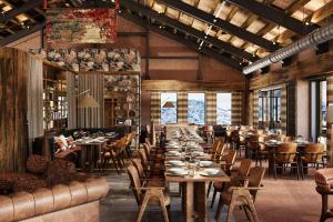 a dining room with tables and chairs and windows at Ceylan Splend'or Uludag, Autograph Collection in Uludar