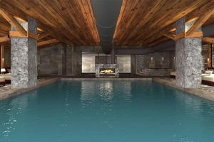 a swimming pool with a fireplace in a house at Ceylan Splend'or Uludag, Autograph Collection  +38 photos