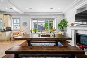 a living room with a table and a fireplace at 1 Bedroom Luxury Retreat in Prime Vancouver in Vancouver