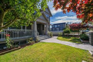 a house with a walkway in front of a yard at 1 Bedroom Luxury Retreat in Prime Vancouver in Vancouver