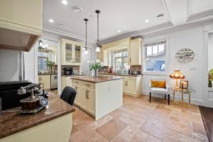 a kitchen with yellow cabinets and a counter top at 1 Bedroom Luxury Retreat in Prime Vancouver in Vancouver