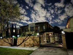an old house with a fence at night at Bentleigh Private 1BR 5min Train Cafes Quiet Cozy in Melbourne