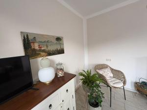 a living room with a television and a chair at Casa mia in Magdeburg