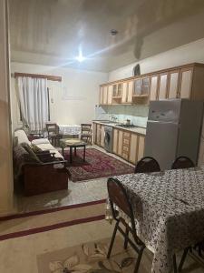 a kitchen with a table and chairs in a room at Vefa's home in Ganja